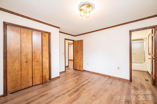 3020 Doc Pugh Rd, Connelly Springs, NC 28612 - unfurnished bedroom with wood finished floors, a textured ceiling, ornamental molding, a closet, and baseboards
