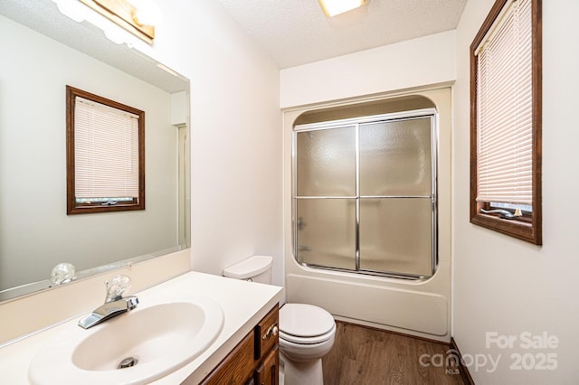 3020 Doc Pugh Rd, Connelly Springs, NC 28612 - full bath featuring wood finished floors, toilet, vanity, bath / shower combo with glass door, and a textured ceiling