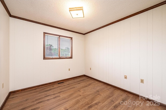 3020 Doc Pugh Rd, Connelly Springs, NC 28612 - unfurnished room featuring wood finished floors, a textured ceiling, ornamental molding, and baseboards