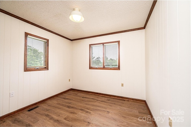 3020 Doc Pugh Rd, Connelly Springs, NC 28612 - spare room featuring healthy amount of natural light, wood finished floors, ornamental molding, a textured ceiling, and baseboards