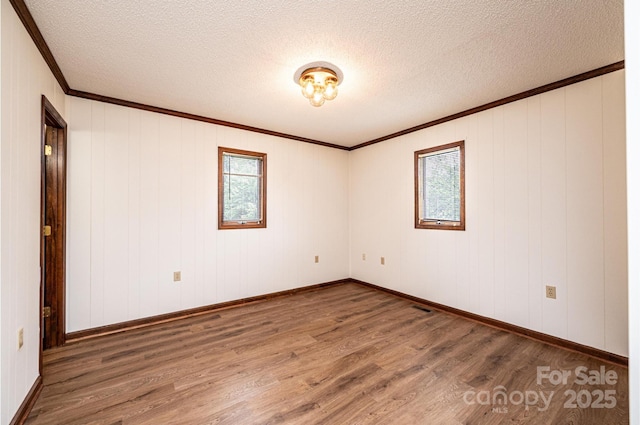 3020 Doc Pugh Rd, Connelly Springs, NC 28612 - unfurnished room with wood finished floors, crown molding, a textured ceiling, and baseboards