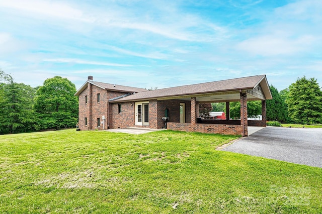 3020 Doc Pugh Rd, Connelly Springs, NC 28612 - view of front of property featuring brick siding, driveway, a front lawn, a chimney, and a patio