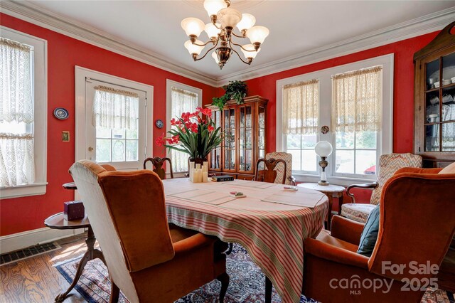 611 E Marion St, Shelby, NC 28150 - dining room with a chandelier, plenty of natural light, baseboards, crown molding, and wood finished floors