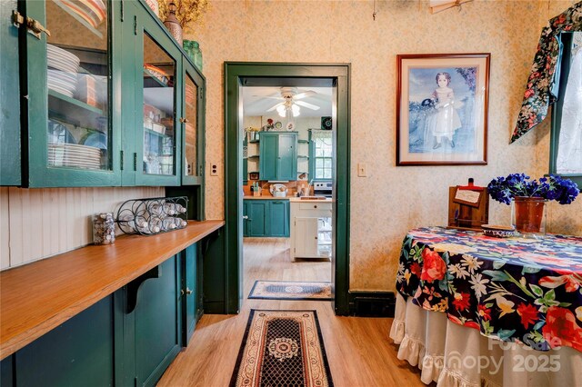 611 E Marion St, Shelby, NC 28150 - dining room with light wood-style flooring, ceiling fan, and wallpapered walls