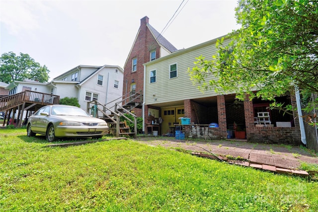 611 E Marion St, Shelby, NC 28150 - rear view of property with stairway, brick siding, and a yard