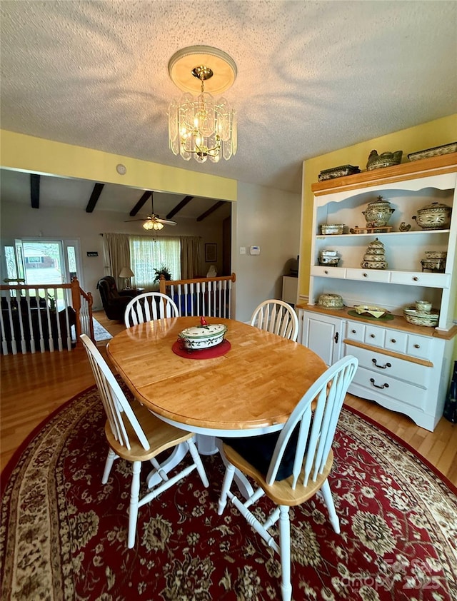 403 Kings Dr, Cherryville, NC 28021 - dining space featuring a chandelier, light wood-style flooring, a ceiling fan, a textured ceiling, and beamed ceiling