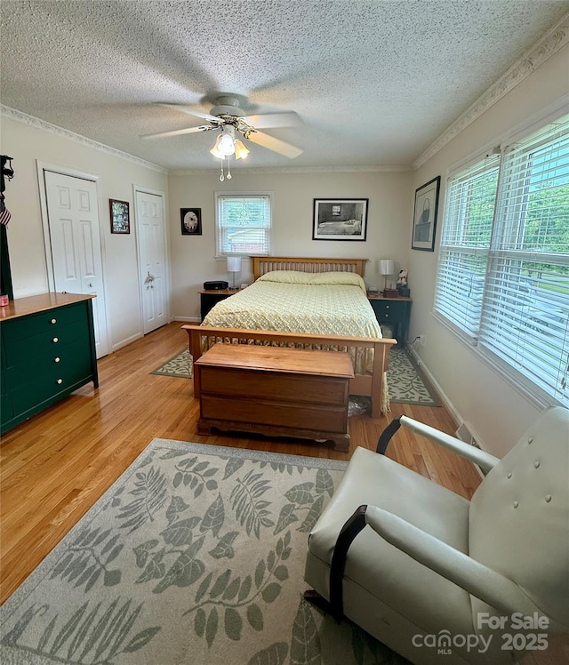 403 Kings Dr, Cherryville, NC 28021 - bedroom featuring light wood finished floors, a textured ceiling, multiple windows, crown molding, and ceiling fan