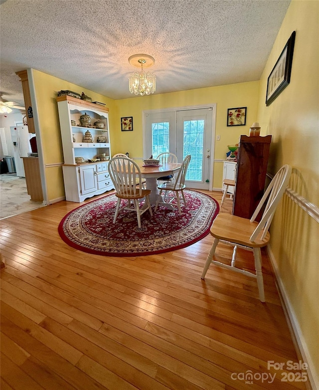 403 Kings Dr, Cherryville, NC 28021 - dining space with a textured ceiling, hardwood / wood-style floors, a chandelier, and ceiling fan