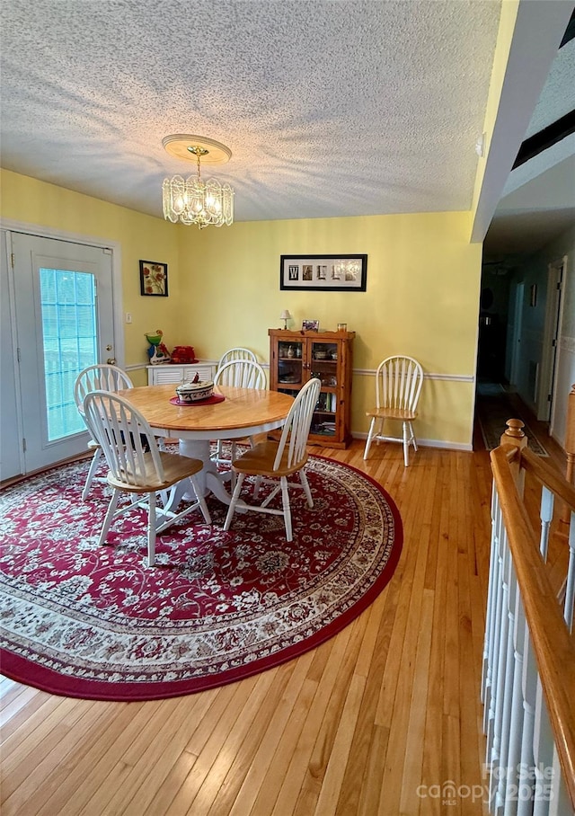 403 Kings Dr, Cherryville, NC 28021 - dining room featuring a textured ceiling, a chandelier, and hardwood / wood-style floors