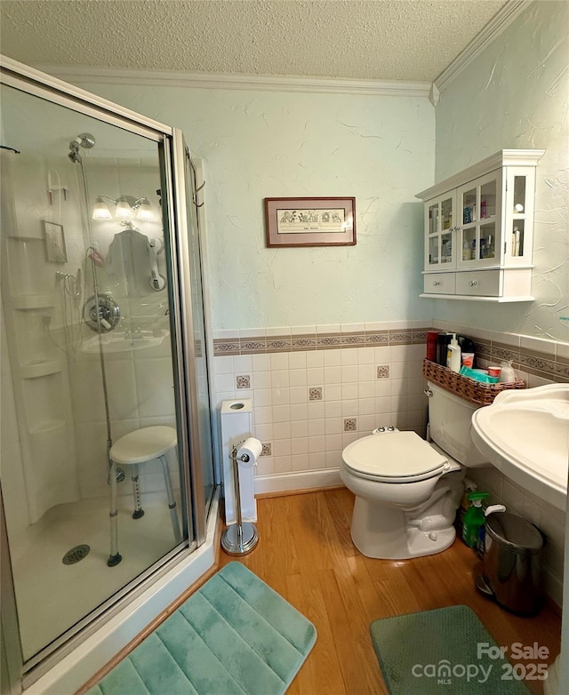 403 Kings Dr, Cherryville, NC 28021 - full bathroom featuring ornamental molding, a textured ceiling, a stall shower, wood finished floors, and tile walls