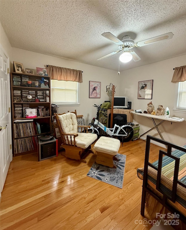 403 Kings Dr, Cherryville, NC 28021 - home office featuring a textured ceiling, healthy amount of natural light, a ceiling fan, and wood finished floors