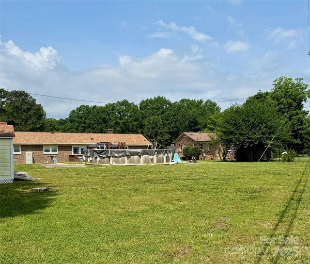 403 Kings Dr, Cherryville, NC 28021 - view of green lawn with a covered pool