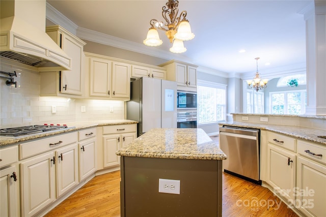 1009 Brookline Dr, Huntersville, NC 28078 - kitchen featuring a chandelier, premium range hood, stainless steel appliances, healthy amount of natural light, and ornamental molding