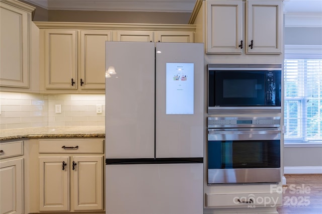 1009 Brookline Dr, Huntersville, NC 28078 - kitchen with freestanding refrigerator, oven, built in microwave, ornamental molding, and cream cabinetry