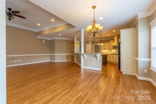 1009 Brookline Dr, Huntersville, NC 28078 - unfurnished living room with a chandelier, a ceiling fan, crown molding, light wood-style flooring, and recessed lighting