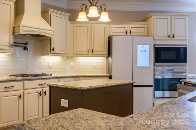 1009 Brookline Dr, Huntersville, NC 28078 - kitchen with premium range hood, stainless steel appliances, ornamental molding, tasteful backsplash, and light stone counters