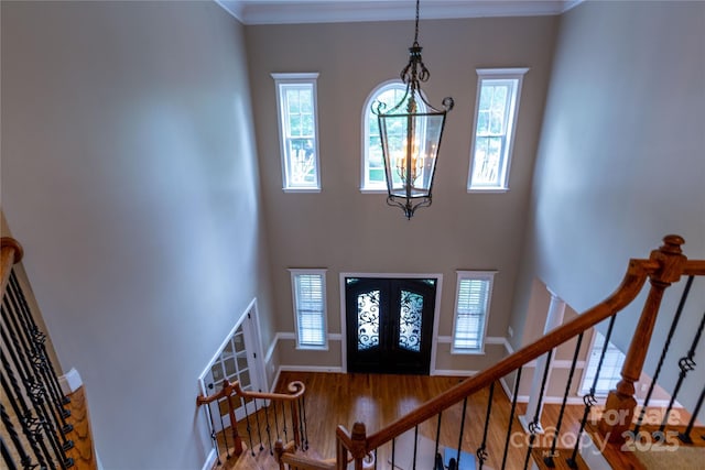 1009 Brookline Dr, Huntersville, NC 28078 - entrance foyer with wood finished floors, french doors, stairway, a high ceiling, and a chandelier