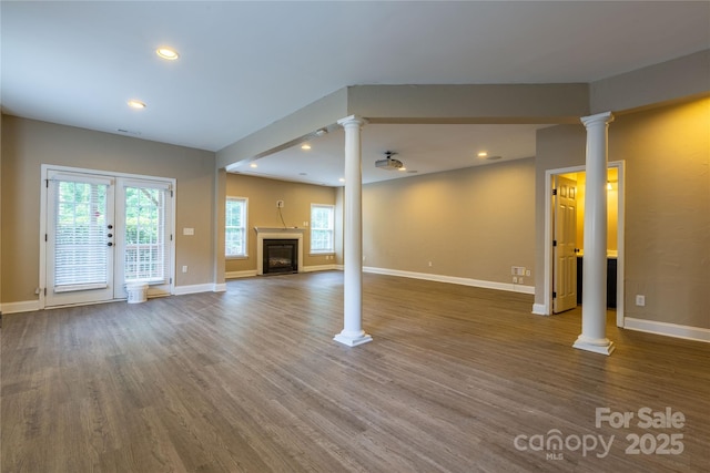 1009 Brookline Dr, Huntersville, NC 28078 - unfurnished living room with decorative columns, wood finished floors, healthy amount of natural light, and recessed lighting