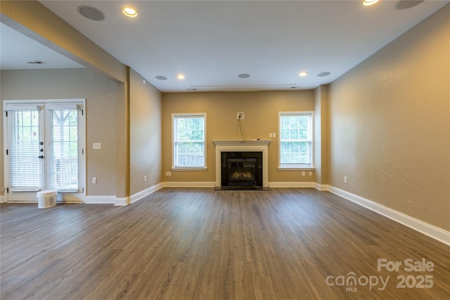 1009 Brookline Dr, Huntersville, NC 28078 - unfurnished living room with plenty of natural light, dark wood-type flooring, a fireplace with flush hearth, and recessed lighting