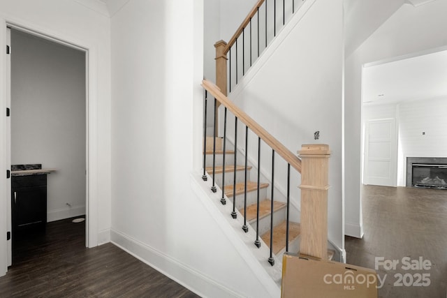 6782 Kingfisher Ct, Denver, NC 28037 - stairway with wood finished floors, baseboards, and a glass covered fireplace