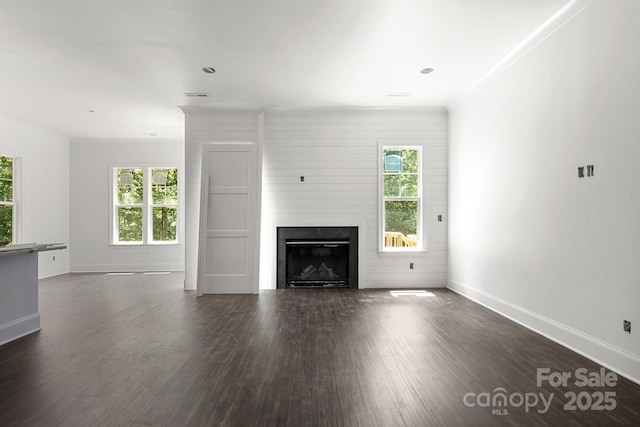 6782 Kingfisher Ct, Denver, NC 28037 - unfurnished living room with healthy amount of natural light, dark wood-style floors, a fireplace, baseboards, and crown molding