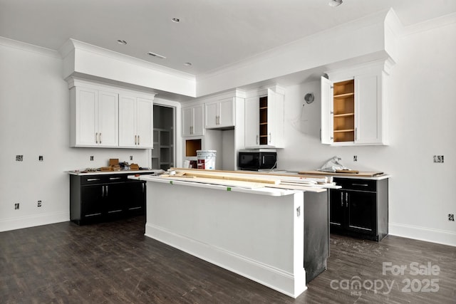 6782 Kingfisher Ct, Denver, NC 28037 - kitchen featuring black microwave, dark cabinets, a kitchen island, open shelves, and crown molding