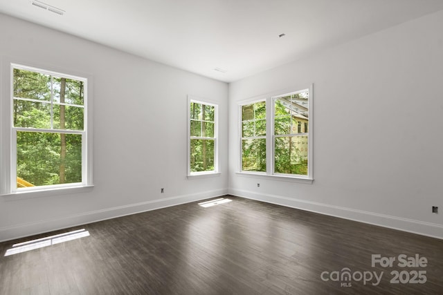 6782 Kingfisher Ct, Denver, NC 28037 - spare room with healthy amount of natural light, baseboards, and dark wood-type flooring
