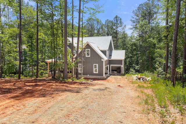 6782 Kingfisher Ct, Denver, NC 28037 - view of front of property with dirt driveway and board and batten siding