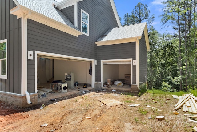 6782 Kingfisher Ct, Denver, NC 28037 - view of home's exterior featuring roof with shingles, board and batten siding, a garage, and driveway