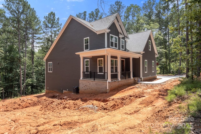 6782 Kingfisher Ct, Denver, NC 28037 - view of side of property with covered porch, roof with shingles, and board and batten siding
