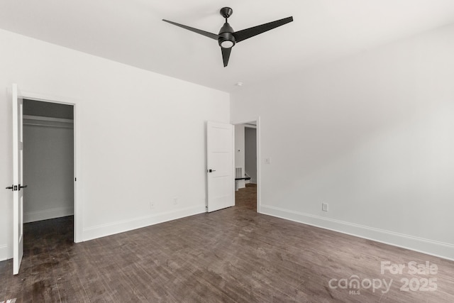 6782 Kingfisher Ct, Denver, NC 28037 - unfurnished bedroom with a walk in closet, a ceiling fan, and dark wood-type flooring