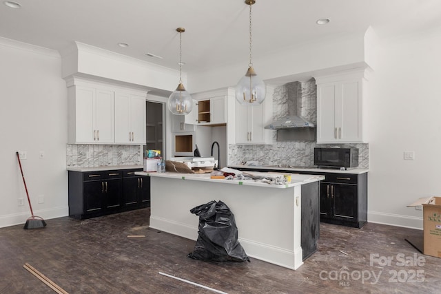 6782 Kingfisher Ct, Denver, NC 28037 - kitchen featuring wall chimney exhaust hood, black microwave, decorative backsplash, white cabinets, and light countertops