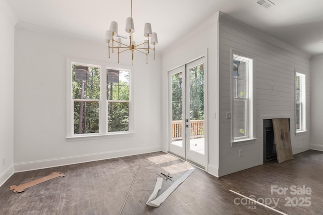 6782 Kingfisher Ct, Denver, NC 28037 - unfurnished dining area with a chandelier, wood finished floors, french doors, and a fireplace