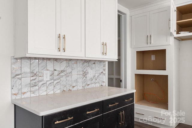 6782 Kingfisher Ct, Denver, NC 28037 - kitchen featuring dark cabinets, white cabinetry, tasteful backsplash, open shelves, and light stone countertops
