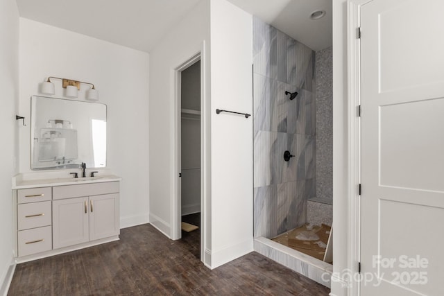 6782 Kingfisher Ct, Denver, NC 28037 - bathroom featuring a walk in shower, vanity, wood finished floors, and a walk in closet