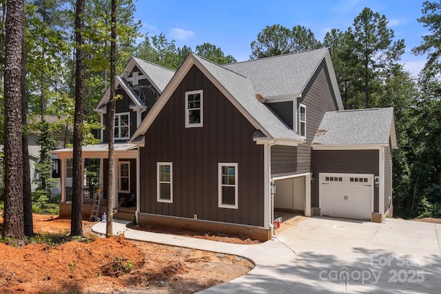 6782 Kingfisher Ct, Denver, NC 28037 - view of front of property with covered porch, board and batten siding, an attached garage, roof with shingles, and driveway