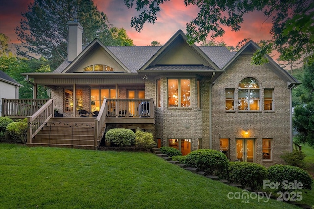 9002 Fair Oak Dr, Sherrills Ford, NC 28673 - rear view of house featuring a chimney, brick siding, a lawn, and stairway