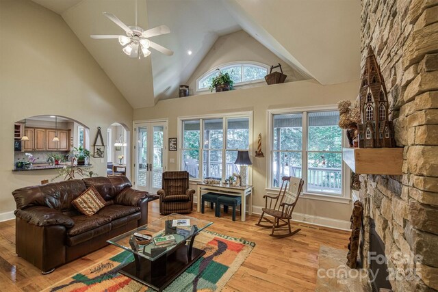 9002 Fair Oak Dr, Sherrills Ford, NC 28673 - living room with light wood-type flooring, a ceiling fan, arched walkways, and high vaulted ceiling