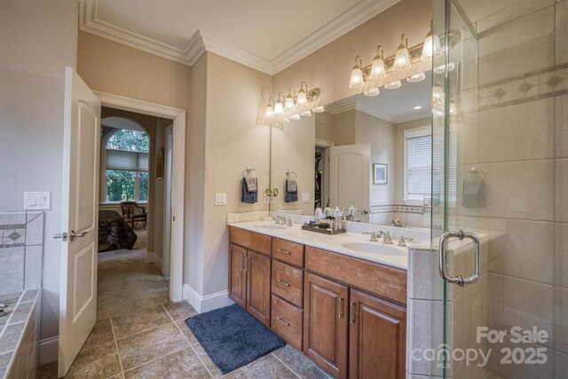 9002 Fair Oak Dr, Sherrills Ford, NC 28673 - ensuite bathroom featuring double vanity, crown molding, a stall shower, and baseboards