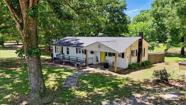 2903 Price Rushing Rd, Monroe, NC 28110 - view of front of home with a chimney, a shingled roof, a front lawn, and a patio area