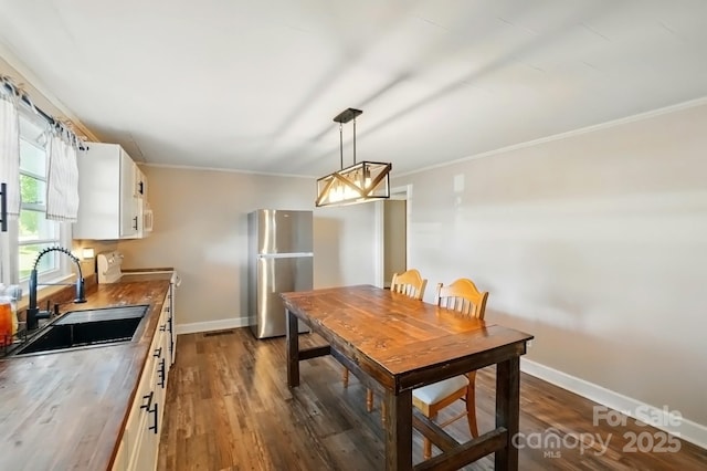2903 Price Rushing Rd, Monroe, NC 28110 - dining space with ornamental molding, dark wood-style flooring, and baseboards