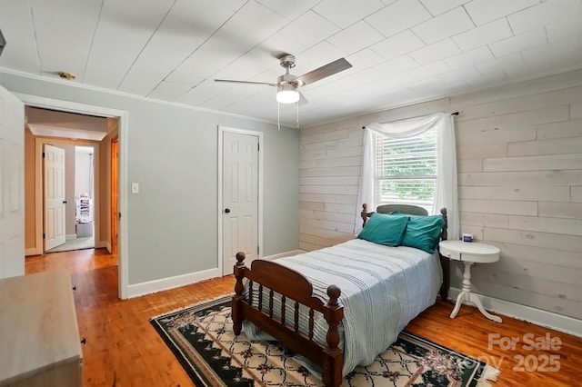 2903 Price Rushing Rd, Monroe, NC 28110 - bedroom with wood finished floors, ceiling fan, wood walls, and ornamental molding