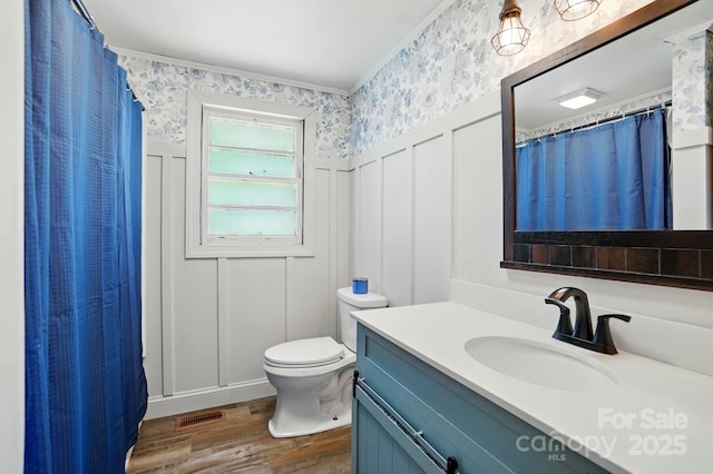 2903 Price Rushing Rd, Monroe, NC 28110 - full bath with a decorative wall, wood finished floors, wallpapered walls, toilet, and vanity