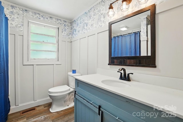 2903 Price Rushing Rd, Monroe, NC 28110 - bathroom with a decorative wall, wood finished floors, vanity, wallpapered walls, and toilet