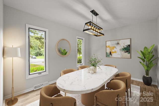 13446 Idlefield Ln, Matthews, NC 28105 - dining room featuring healthy amount of natural light, light wood finished floors, and baseboards