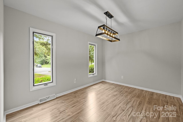 13446 Idlefield Ln, Matthews, NC 28105 - unfurnished room featuring healthy amount of natural light, wood finished floors, and baseboards
