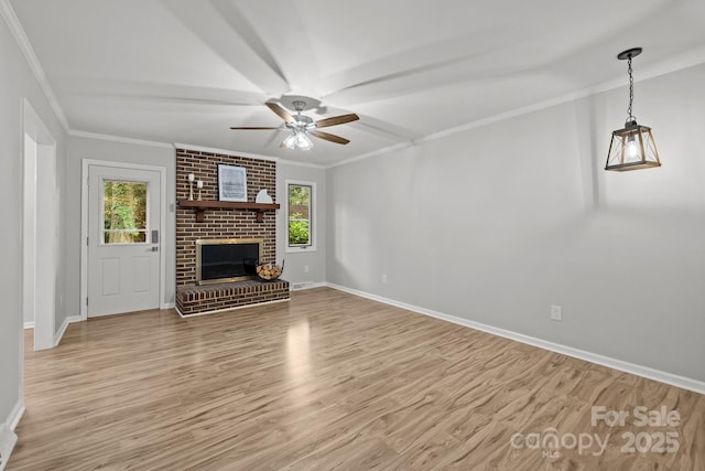 13446 Idlefield Ln, Matthews, NC 28105 - unfurnished living room featuring plenty of natural light, ceiling fan, baseboards, and crown molding