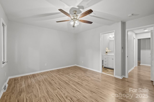 13446 Idlefield Ln, Matthews, NC 28105 - unfurnished bedroom with light wood finished floors, baseboards, ensuite bath, and a ceiling fan