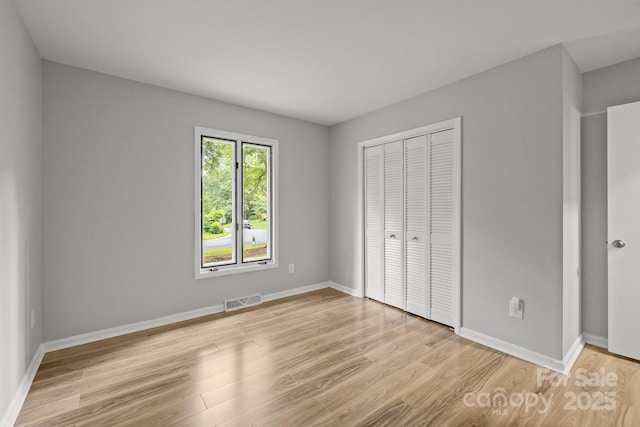 13446 Idlefield Ln, Matthews, NC 28105 - unfurnished bedroom with light wood-style floors, a closet, and baseboards