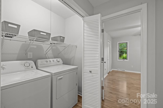 13446 Idlefield Ln, Matthews, NC 28105 - washroom with washer and clothes dryer, light wood-type flooring, and baseboards